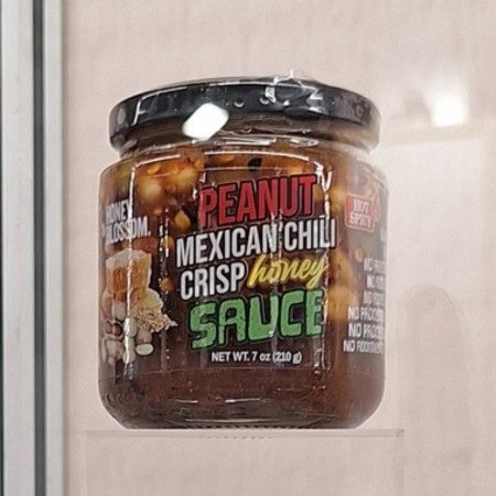 Peanut Mexican chilli crisp honey sauce as a bold sweet heat condiment.