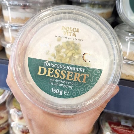 Couscous yoghurt dessert with apricot and pistachio topping.